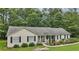 Charming ranch-style home with a welcoming front porch and well-manicured lawn and mature trees at 105 Laney Ct, Mcdonough, GA 30252