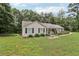 Charming home with a welcoming front porch and landscaping, set on a spacious green lot surrounded by trees at 105 Laney Ct, Mcdonough, GA 30252