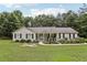 Charming ranch-style home with a welcoming front porch and well-manicured lawn and landscaped garden at 105 Laney Ct, Mcdonough, GA 30252