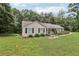 Charming ranch-style home with a welcoming front porch and well-manicured lawn and mature trees at 105 Laney Ct, Mcdonough, GA 30252