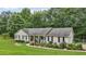 Well-kept single-story home featuring a welcoming front porch and lush green lawn at 105 Laney Ct, Mcdonough, GA 30252