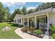 Inviting covered front porch with sidewalk leading to a well-manicured lawn at 105 Laney Ct, Mcdonough, GA 30252