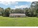 Ranch-style home on a sprawling green lot, featuring a classic design with black shutters and a well-maintained lawn at 105 Laney Ct, Mcdonough, GA 30252