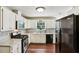 Modern kitchen features white cabinets, stainless steel appliances, and granite countertops at 105 Laney Ct, Mcdonough, GA 30252