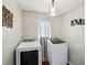 Modern laundry room featuring front load washer and dryer at 105 Laney Ct, Mcdonough, GA 30252
