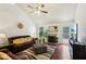 Cozy living room with fireplace, hardwood floors, ceiling fan, and comfortable seating for relaxation at 105 Laney Ct, Mcdonough, GA 30252