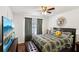 Comfortable main bedroom with a ceiling fan, patterned bedding, and a mounted TV for relaxation at 105 Laney Ct, Mcdonough, GA 30252