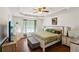 Main bedroom featuring hardwood floors, a ceiling fan, and a large window at 105 Laney Ct, Mcdonough, GA 30252
