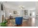 Open-concept living room with a cozy fireplace, hardwood floors, and comfortable seating arrangement at 15 Azalea Lakes Ct, Dallas, GA 30157