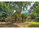Lush backyard featuring mature trees, landscaping, and a deck perfect for outdoor entertaining at 170 Glen Eagle Way, Mcdonough, GA 30253
