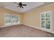 Carpeted bedroom with tray ceiling, natural light and shuttered windows at 170 Glen Eagle Way, Mcdonough, GA 30253