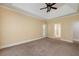 Spacious bedroom with plush carpeting and well-lit entry to bathroom at 170 Glen Eagle Way, Mcdonough, GA 30253