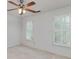 Bedroom with hardwood floors, white walls, and natural light from shuttered windows at 170 Glen Eagle Way, Mcdonough, GA 30253
