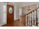 Welcoming foyer with hardwood floors, a decorative front door, and a view into the adjacent dining room at 170 Glen Eagle Way, Mcdonough, GA 30253