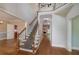Spacious foyer with hardwood floors, staircase, and views into the living and dining areas at 170 Glen Eagle Way, Mcdonough, GA 30253