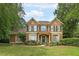 Charming two-story home with well-manicured lawn and mature trees, featuring green shutters and a covered entryway at 170 Glen Eagle Way, Mcdonough, GA 30253