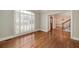 Bright living room with hardwood floors, large windows, and elegant trim details at 170 Glen Eagle Way, Mcdonough, GA 30253
