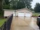 Exterior view of a two-car garage with adjacent storage area and a paved driveway at 3964 Hamilton Mill Rd, Buford, GA 30114