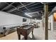 Open basement with painted ceiling beams, a pool table, foosball table, and seating area at 8070 Johnson Rd, Palmetto, GA 30268