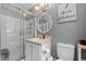 Bathroom features a glass enclosed shower, vanity with sink, mirror, and toilet at 8070 Johnson Rd, Palmetto, GA 30268