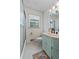Bathroom featuring storage closet with a tiled shower/tub and blue vanity at 8070 Johnson Rd, Palmetto, GA 30268