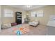 Bright bedroom with a ceiling fan, colorful rug, bookshelf, and two windows at 8070 Johnson Rd, Palmetto, GA 30268