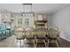 Open-concept dining area with a view of the backyard and an exposed brick fireplace at 8070 Johnson Rd, Palmetto, GA 30268