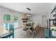 Dining room with seating for ten, exposed brick fireplace and outdoor access to the pool at 8070 Johnson Rd, Palmetto, GA 30268