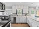 This kitchen is equipped with stainless appliances, white cabinetry, and a decorative backsplash at 8070 Johnson Rd, Palmetto, GA 30268