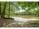 A scenic lake with lush greenery and a boat ramp is perfect for nature enthusiasts at 8070 Johnson Rd, Palmetto, GA 30268