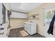 Laundry room with washer, dryer, shelving, and convenient access to the outside at 8070 Johnson Rd, Palmetto, GA 30268