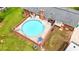 Aerial view of the backyard pool with brick surround and outdoor seating area at 8070 Johnson Rd, Palmetto, GA 30268