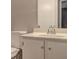 A well-lit bathroom featuring a vanity with a sink and a toilet at 129 Lester Nw Rd, Lawrenceville, GA 30044