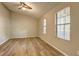 Empty bedroom with hardwood floors, vaulted ceilings, and bright windows that let in natural light at 129 Lester Nw Rd, Lawrenceville, GA 30044