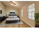 Spacious primary bedroom featuring a ceiling fan, two windows, and well-appointed decor at 129 Lester Nw Rd, Lawrenceville, GA 30044