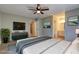This staged bedroom features hardwood floors, a ceiling fan, and attached bathroom at 129 Lester Nw Rd, Lawrenceville, GA 30044