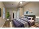 This staged bedroom is spacious, and features hardwood floors, a ceiling fan, and neutral walls at 129 Lester Nw Rd, Lawrenceville, GA 30044