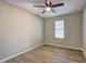 Spacious bedroom with hardwood floors, a ceiling fan, and a window allowing natural light at 129 Lester Nw Rd, Lawrenceville, GA 30044