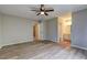Spacious bedroom featuring hardwood floors, a ceiling fan, and attached bathroom at 129 Lester Nw Rd, Lawrenceville, GA 30044