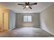 Spacious bedroom featuring hardwood floors, ceiling fan, and neutral walls at 129 Lester Nw Rd, Lawrenceville, GA 30044