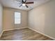 Unfurnished bedroom, highlighting the wood-look flooring, ceiling fan, and natural light at 129 Lester Nw Rd, Lawrenceville, GA 30044