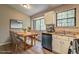 Dining area featuring stainless steel appliances, lots of cabinets, hardwood floors, and a bright window at 129 Lester Nw Rd, Lawrenceville, GA 30044