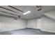 Spacious two-car garage with updated lighting and freshly painted walls, perfect for storage or workshop at 129 Lester Nw Rd, Lawrenceville, GA 30044