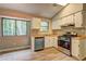 Well-lit kitchen featuring stainless steel appliances, lots of cabinets, and a window overlooking trees at 129 Lester Nw Rd, Lawrenceville, GA 30044