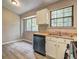 Efficient kitchen features stainless steel dishwasher, double sink, and bright natural light at 129 Lester Nw Rd, Lawrenceville, GA 30044