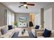 Nicely staged living room with hardwood floors, staircase, neutral paint, ceiling fan, and lots of natural light at 129 Lester Nw Rd, Lawrenceville, GA 30044