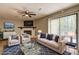 Nicely staged living room with fireplace, hardwood floors, ceiling fan, and sliding doors to outdoor deck at 129 Lester Nw Rd, Lawrenceville, GA 30044