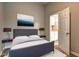 Primary bedroom with ensuite bathroom, featuring modern decor, rug, and stylish lamps at 129 Lester Nw Rd, Lawrenceville, GA 30044