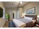 Primary bedroom showcasing modern decor, hardwood floors, and an ensuite bathroom at 129 Lester Nw Rd, Lawrenceville, GA 30044