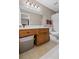 Neutral bathroom featuring a wooden vanity, a large mirror with sconce lighting, and a standard toilet at 202 Berkeley Woods Dr, Duluth, GA 30096